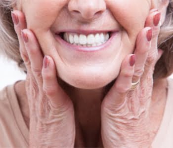 How can tooth implants be used for holding dentures for Epsom area patients?