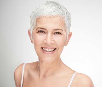 Beautiful smilling senior woman in front of white background